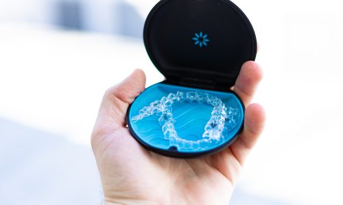 Men,Holding,Invisalign,Braces,In,Hand
